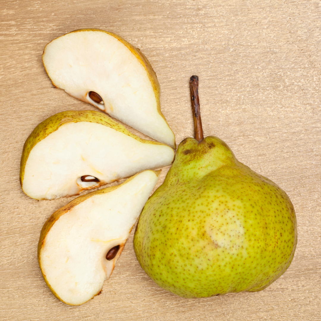 half cut pear and three pear slices on wooden board